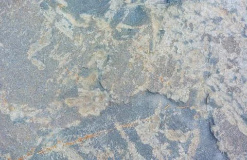 The texture of natural stone is light gray. Stock Photos