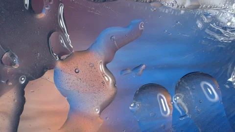 Texture, oil texture moves on the bottom of the container, from below shines Vidéo 129854091