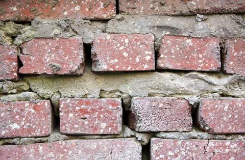 Texture of an old abandoned brick old wall with cement Stock Photos
