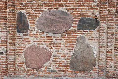 The texture of the old ancient medieval antique stone hard peeling cracked brick Stock Photos