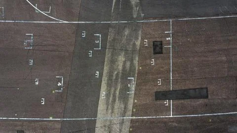 The texture of old and worn out asphalt. Drone view of old road Stock Photos