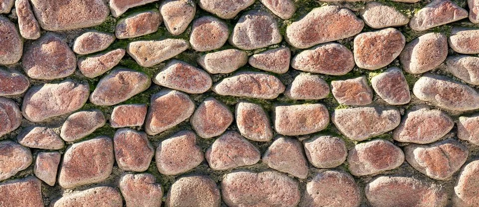 Texture of an old antique stone wall. Abstract background. Stock Photos