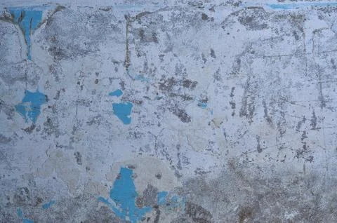 Texture of the old battered wall blue peeling paint, concrete, gray cement gr Stock Photos