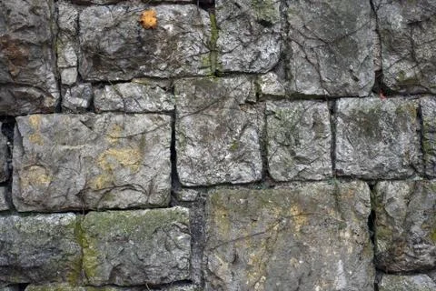 Texture of old big stone wall. Backdrop of medieval historic building Stock Photos