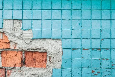 Texture of old blue tile wall. Background of Wall fragment with broken tile a Stock Photos