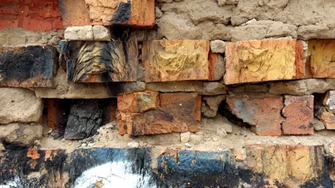 Texture of an old brick wall with burnt paint and peeling plaster Stock Footage 329353496