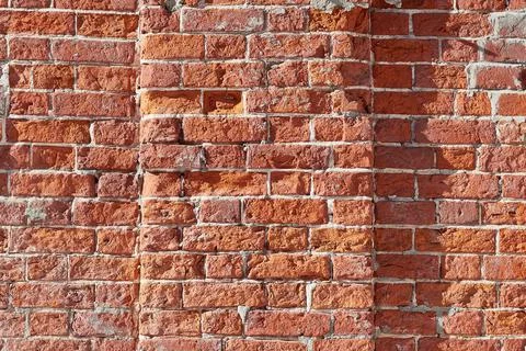 The texture of an old brick wall with cracks. The aesthetics of destruction. Stock Photos
