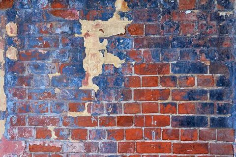 The texture of an old brick wall with cracks. The aesthetics of destruction. Stock Photos