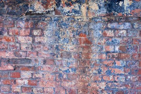 The texture of an old brick wall with cracks. The aesthetics of destruction. Stock Photos