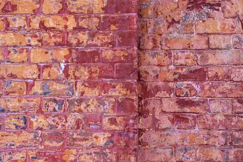 The texture of an old brick wall with cracks. The aesthetics of destruction. Stock Photos