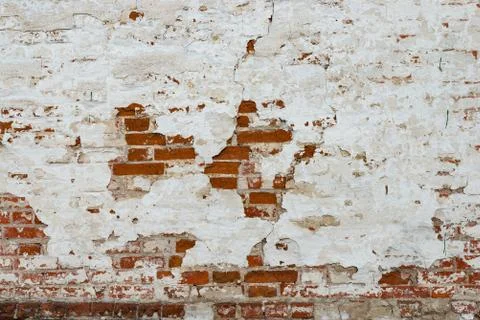 The texture of the old brick wall painted white with peeling paint Stock Photos