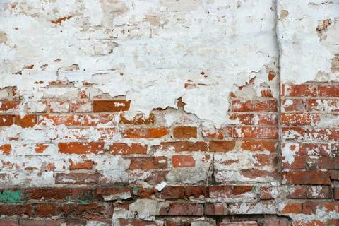 The texture of the old brick wall painted white with peeling paint Stock Photos
