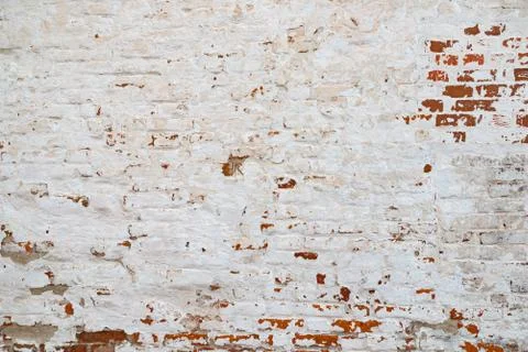 The texture of the old brick wall painted white with peeling paint Stock Photos