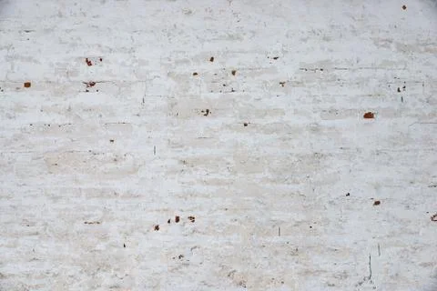 The texture of the old brick wall painted white with peeling paint Stock Photos