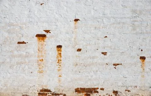 The texture of the old brick wall painted white with peeling paint Stock Photos