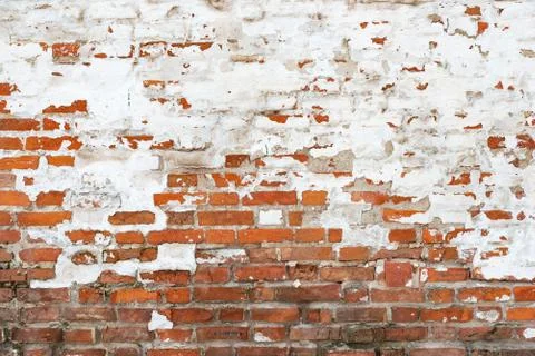 The texture of the old brick wall painted white with peeling paint Stock Photos