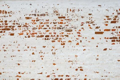 The texture of the old brick wall painted white with peeling paint Stock Photos
