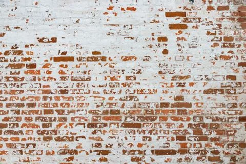 The texture of the old brick wall painted white with peeling paint Stock Photos