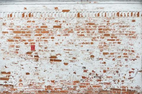The texture of the old brick wall painted white with peeling paint Stock Photos