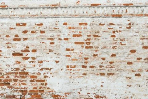 The texture of the old brick wall painted white with peeling paint Stock Photos