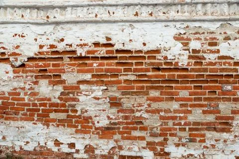 The texture of the old brick wall painted white with peeling paint Stock Photos