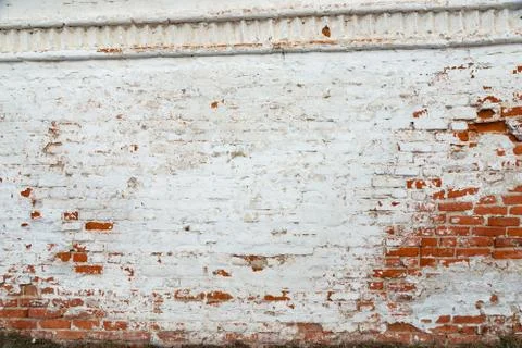 The texture of the old brick wall painted white with peeling paint Stock Photos