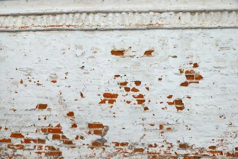 The texture of the old brick wall painted white with peeling paint Stock Photos
