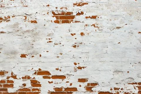 The texture of the old brick wall painted white with peeling paint Stock Photos