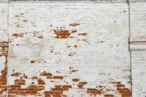 The texture of the old brick wall painted white with peeling paint Stock Photos
