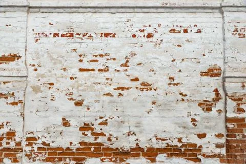 The texture of the old brick wall painted white with peeling paint Stock Photos