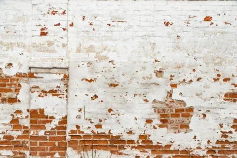 The texture of the old brick wall painted white with peeling paint Stock Photos