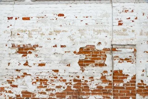 The texture of the old brick wall painted white with peeling paint Stock Photos