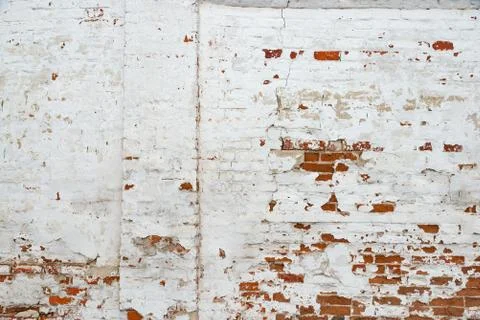 The texture of the old brick wall painted white with peeling paint Stock Photos