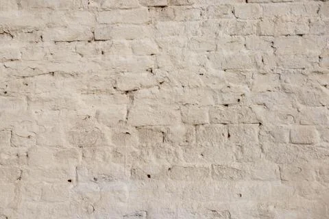 The texture of the old brick wall painted white with peeling paint Photos