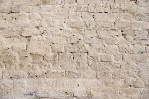The texture of the old brick wall painted white with peeling paint Stock Photos