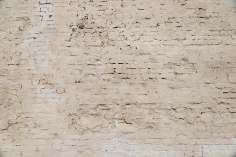 The texture of the old brick wall painted white with peeling paint Stock Photos