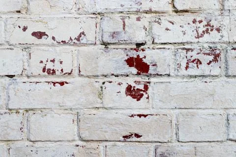 The texture of the old brick wall painted white with peeling paint Photos