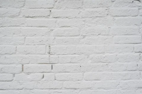 Texture of an old brick wall painted with white paint Stock Photos