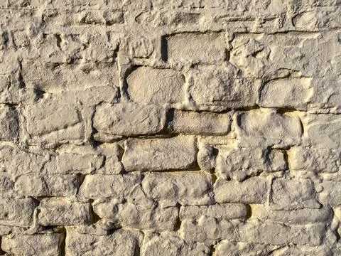Texture of an old brick wall painted beige Stock Photos