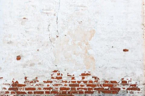 Texture of old brick wall with peeling plaster. Beautiful background of old b Stock Photos