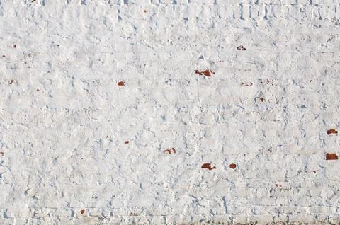 Texture of old brick wall with peeling plaster. Beautiful background of old b Stock Photos
