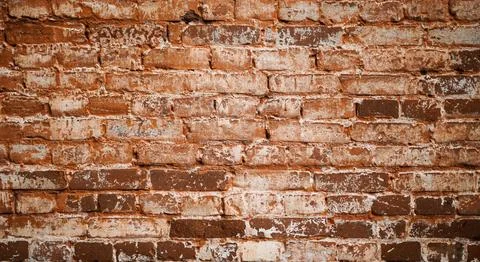 The texture of an old brick wall. The surface of the wall is damaged. 스톡 사진