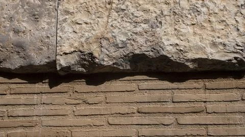 Texture of an old brick wall together with a rock Stock Photos