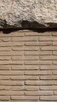 Texture of an old brick wall together with a rock Stock Photos