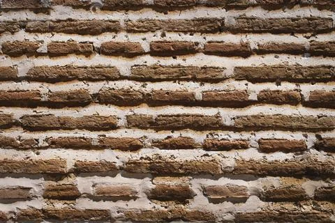 Texture of an old brick wall in a warm and very textured tone. Stock Photos