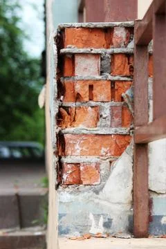 The texture of the old bricks and beige plaster of the house. Stock Photos
