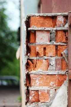 The texture of the old bricks and beige plaster of the house. Stock Photos