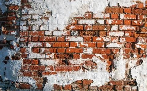 Texture of old brickwork with shabby paint on the wall. Red brick. Foto stock