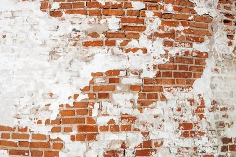 Texture of old brickwork with shabby paint on the wall. Red brick. Stock Photos