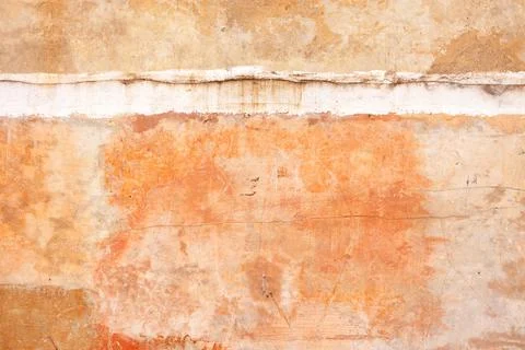 Texture of an old clay wall with cracks and scratches and an interfloor seam. Stock Photos